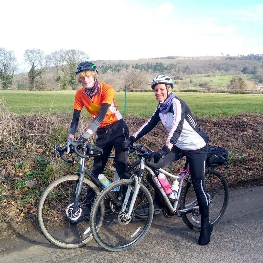 two cyclists on a country road